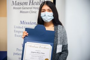 Gregoria Alonzo Tomas holding Mason Health scholarship 
