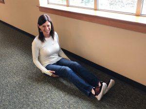 Jennifer Penrose sitting on ground with legs outstretched, knees slightly bent 