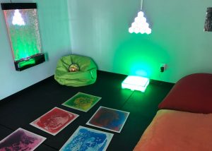 Sensory room in Sensory Tool House with  different textures on the wall and soothe with fiberoptic lights.  
