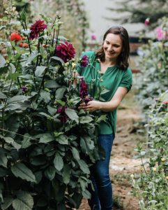 Valerie Gerrits, owner of Cedar Flats Flower Farm, pruning a rose bush