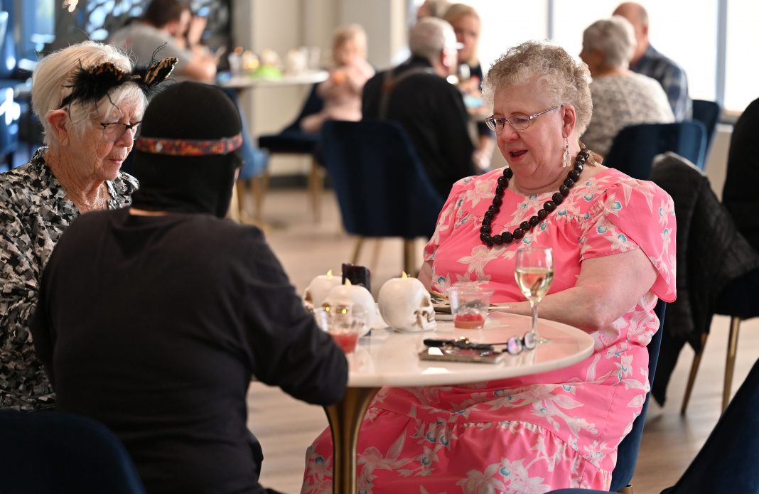 people sitting at tables at an event at Harbor Heights