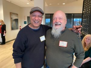 two male Harbor Heights residents smiling together at an event