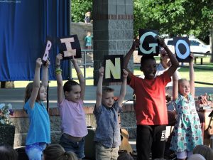 kids holding up letters that spell BINGO at Huntamer Park's Lacey In Tune
