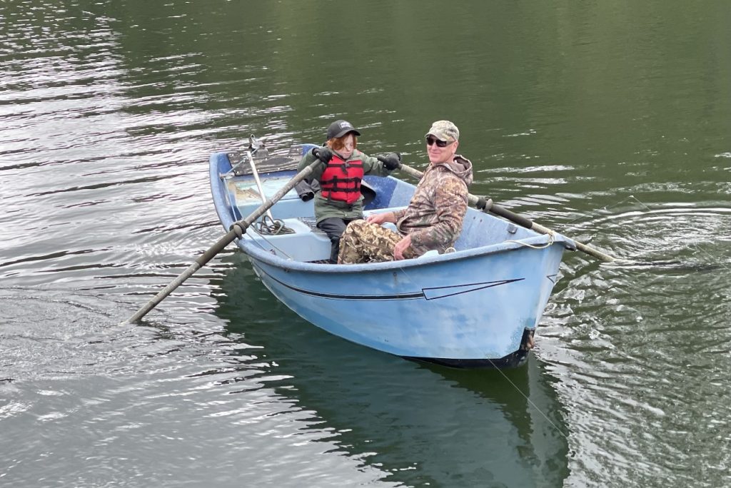 boy and man in boat on lake