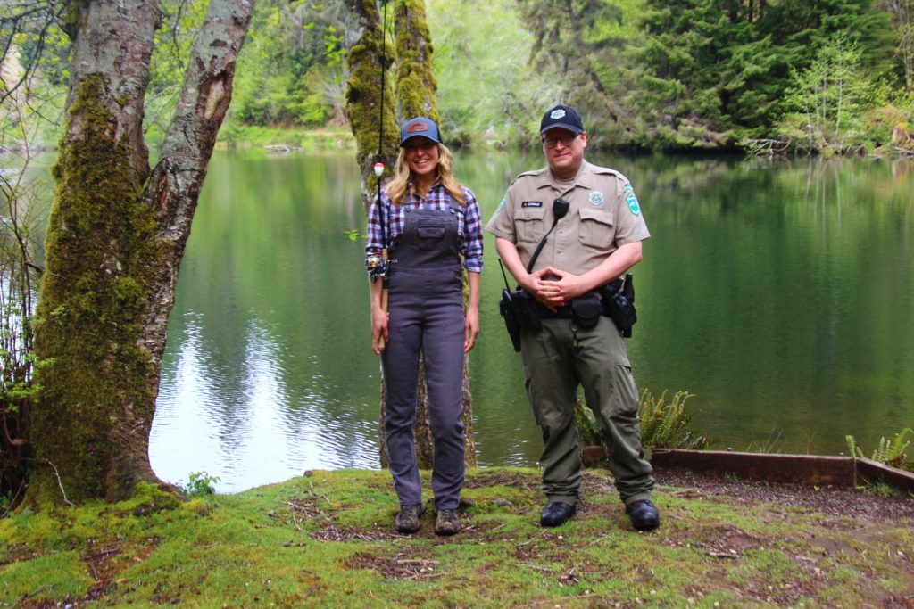 Jess Caldwell standing with Park Ranger Nick Schwalb by lake