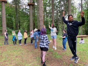 kids playing a game in the woods 