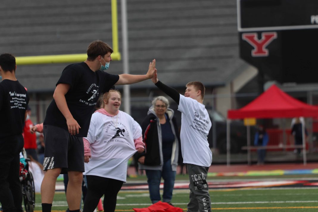 kids getting a high five from an adult at Yelm Community School's Day of Champions