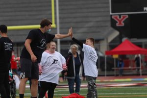 kids getting a high five from an adult at Yelm Community School's Day of Champions