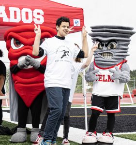 mascots cheering a kid at the Day of Champions