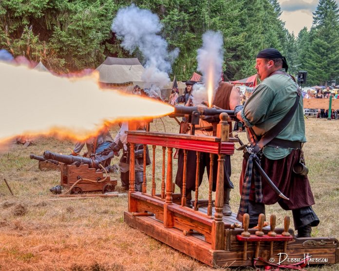 people dressed as pirates firing a cannon