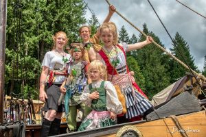 a group of kids in fantasy costumes on a pirate ship at the Northwest Pirate Festival