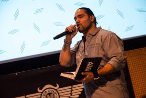 Jose Gutierrez Jr. on stage speaking at an event