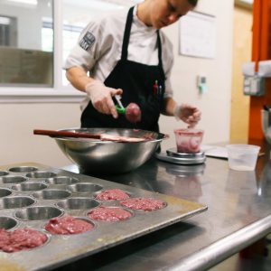 Chefs make raspberry muffins in Farm to Fit's Portland kitchen