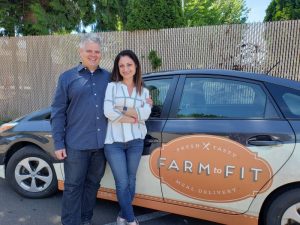 G. Scott Brown and Dre Slaman, Farm to Fit co-owners standing by a Farm to Fit car