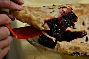 piece of berry pie being dished out