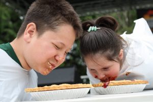 kids eating pie at  pie-eating contest at the Nisqually Valley Barbecue Rally