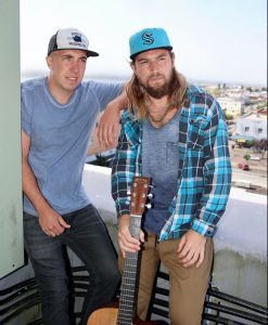 The Olson Brother sitting together on a roof