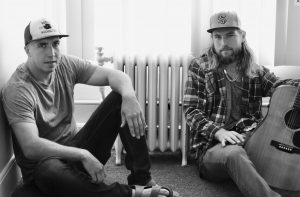 Isaac and Luke Olson sitting on the floor together