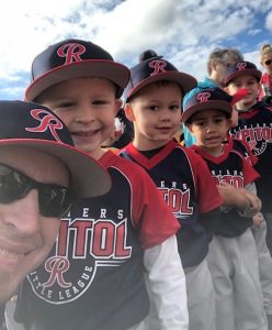 a bunch of young kids in baseball uniforms