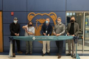 Representatives from Puget Sound Energy and the Olympia School District cut the ribbon on the completed Olympia High School Solar site in November 2021. 