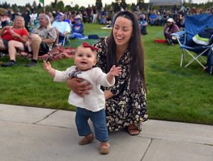 women with child on grass at Dune Concerts in Tacoma