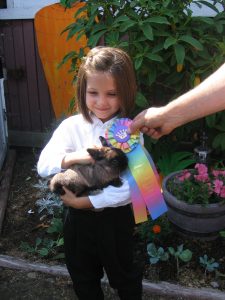 Eva holding one of her rabbits after showing at the Thurston County Fair in 2009.