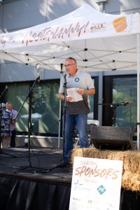 Thurston EDC Board President Elect Mark Steepy on stage at the 2021 Hootenanny