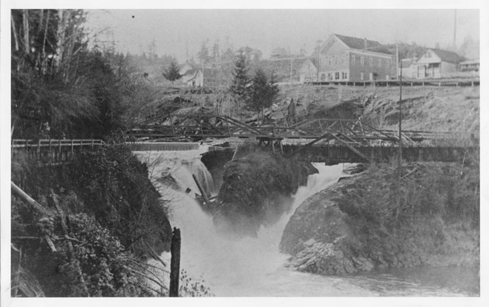 The footbridge, circa 1890, with Tumwater homes and businesses in the background.