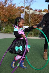 young girl playing with two hula hoops at LoveOly SummerFest 