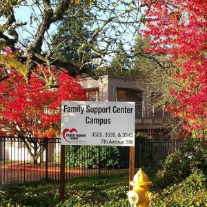 Family Support Center future housing units land with trees and an FSCSS sign