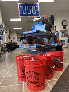 Candy in large red 10-gallon buckets for USO's Trunk or Treat