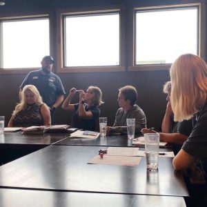 staff at a table at the Lincoln Creek Lumber company summit.