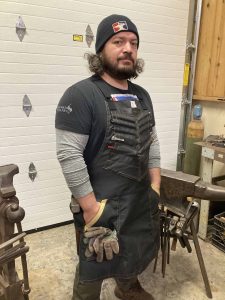 Mareko Maumasi standing in his workspace