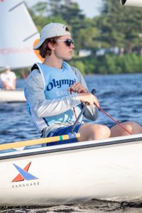 high school sailboat team member sitting in a sailboat in Olympia