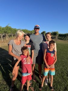 Reid and Samantha Hamblet and their four children standing in a field