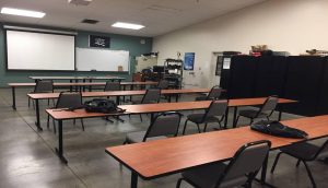 classroom with empty tables and chairs at SPSCC