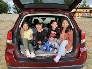 kids in the back of a hatchback car with the trunk up for South Sound Parent to Parent