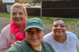 three women taking a selfie, smiling into the camera