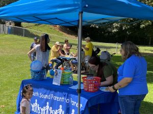 pop up tent with people around it a Mother's Day event with South Sound Parent to Parent