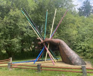 giant sculpture of a hand holding large colred sticks at Monarch Sculpture Park 