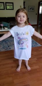  A young Pacific County library patron shows off the T-shirt she made at home as one of her Summer Library Program activities.