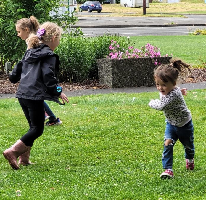 Library friends play together during an outdoor storytime hosted by Montesano Timberland Library.