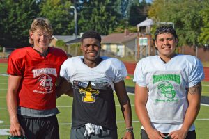 Tumwater seniors Alex Overbay, Carlos Matheney and Lolomana’ia Hafoka standing in a row