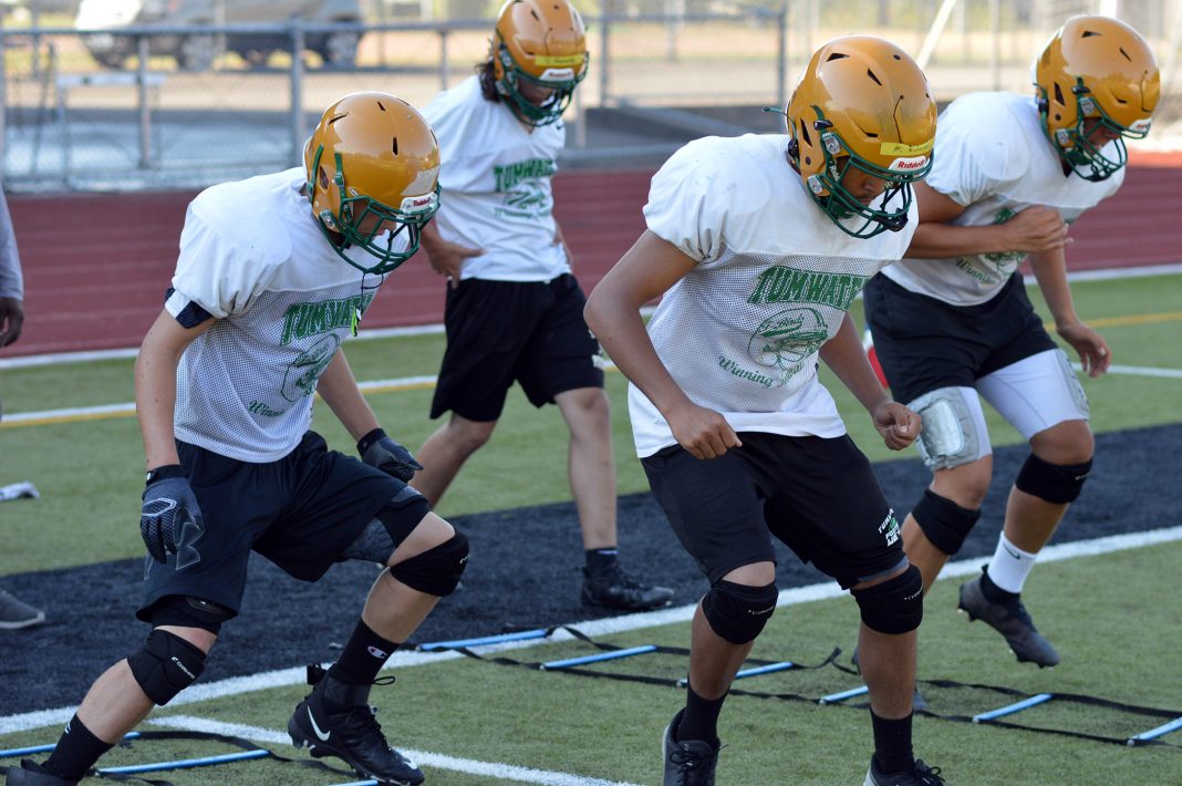 Tumwater players run through a conditioning drill during a pre-season practice.