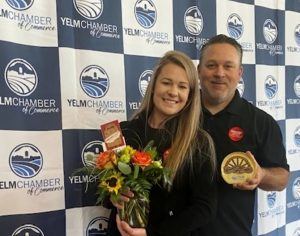 Greg and Stefanie Vinyard from Grocery Outlet accepting their Wagon Wheel Commitment to Community Award at the Yelm Chamber of Commerce Awards event.
