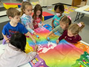 kids painting a large piece of fabric at the South Sound Dance Fine Arts Club