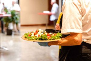 Person carry a plate of appetizers