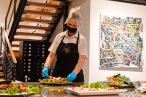 Bayview Catering worker setting up a plate of food