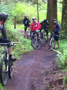 a group of mountain bikers on the Fall Creek trail in the Capitol Forest