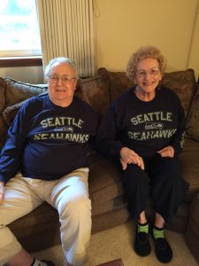 Charlie Jackman and his wife Patricia sitting on a couch